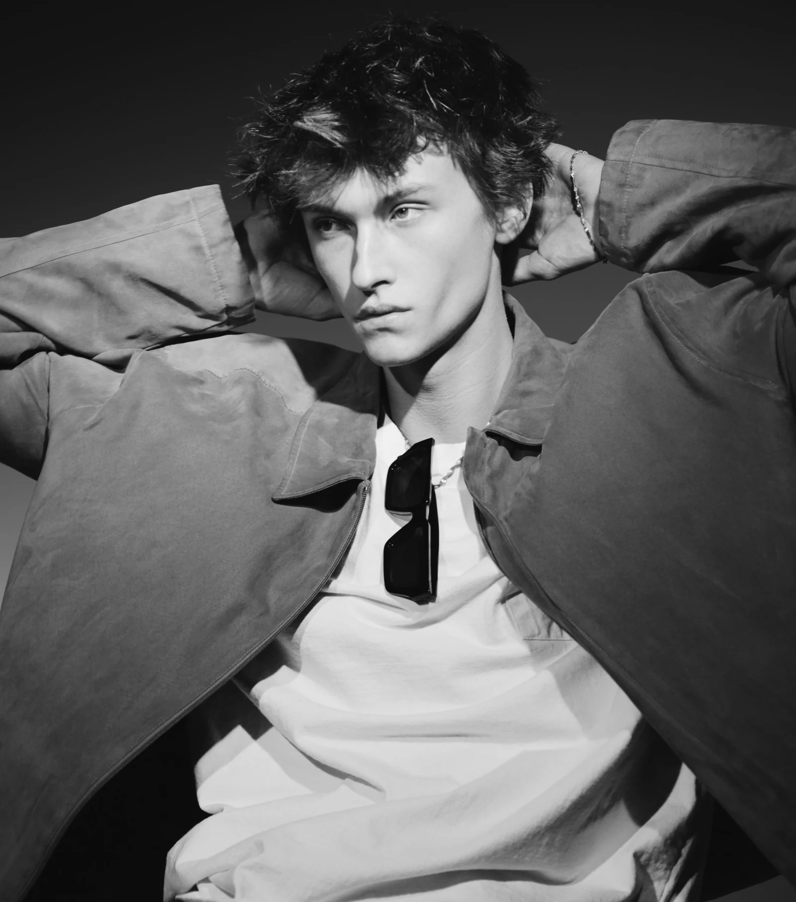 Black-and-white editorial portrait of Kesten Taylor in an open jacket.