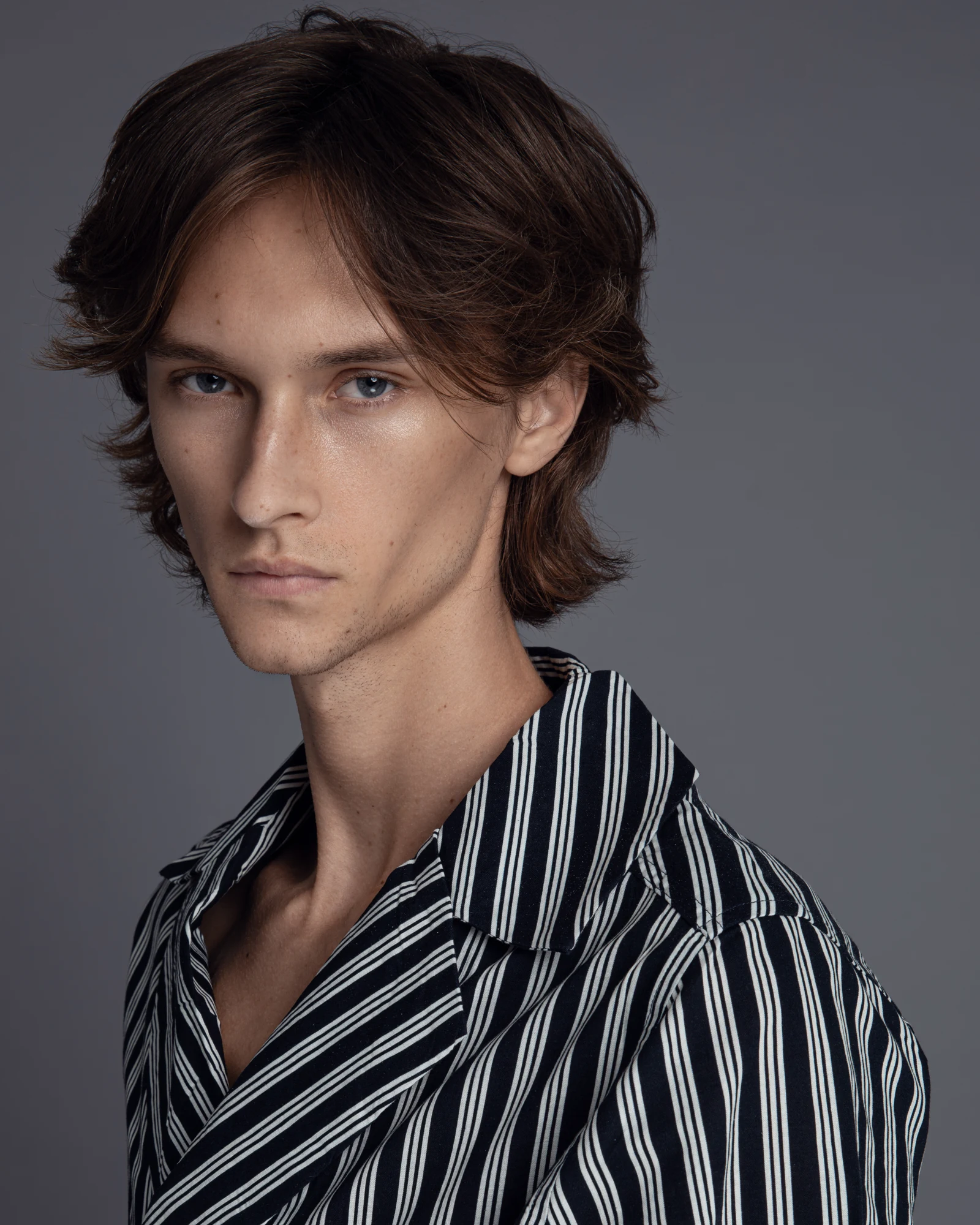 Kesten Taylor in a striped shirt, studio portrait.
